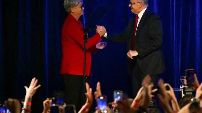 Australia's Foreign Minister Penny Wong (L) with Australia's Prime Minister Anthony Albanese after he won the general election in Sydney, May 3, 2025.
