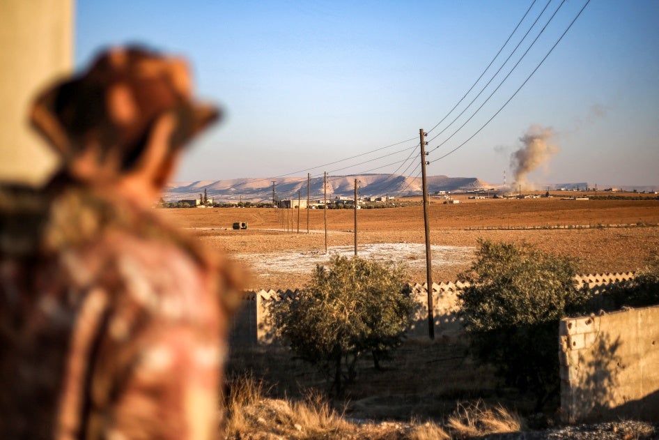 A fighter of the Turkish-backed Syrian National Army faction looks towards a bombardment near the Tishrin Dam in the vicinity of Manbij, in the east of Syria's northern Aleppo province, on January 10, 2025.